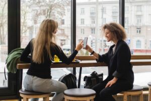 Friends exchange money in coffee shop