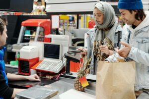 Couple using mobile payments while grocery shopping