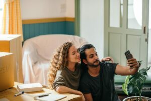 couple take selfie in new home